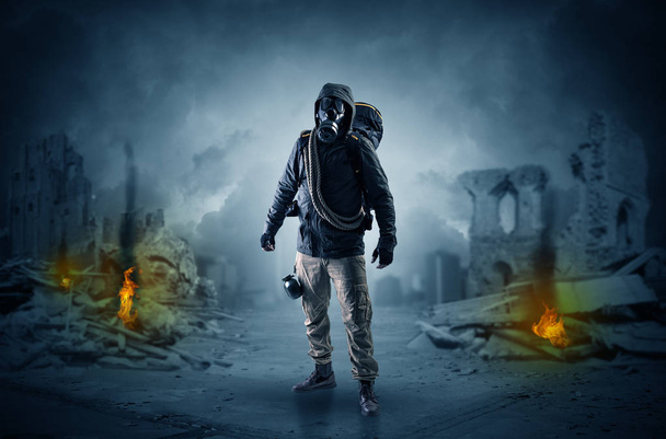 After catastrophe men coming in gas mask and arms - Фото, изображение