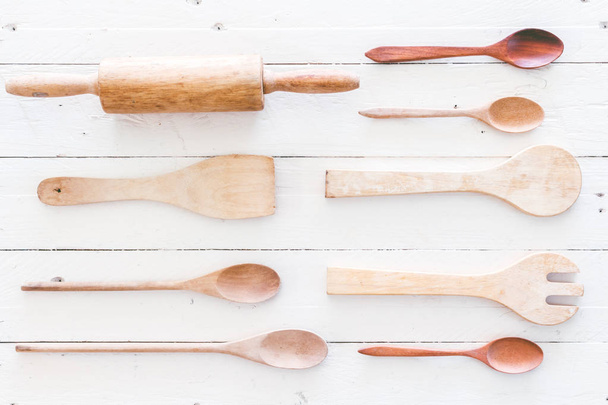 Wooden kitchen utensils on white  wooden background - Foto, afbeelding