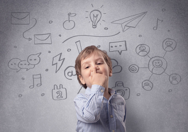 Smart kid in front of a drawn up grey wall - Foto, Bild