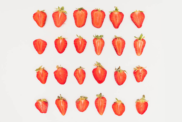 Rows of cut strawberries isolated on white background - Photo, Image