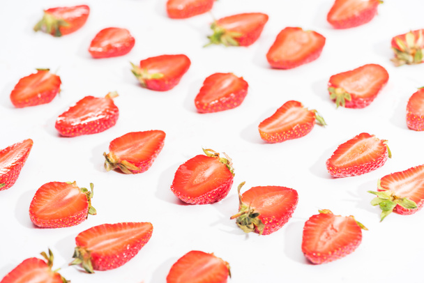 Fresh cut strawberries in rows on white background - Photo, Image