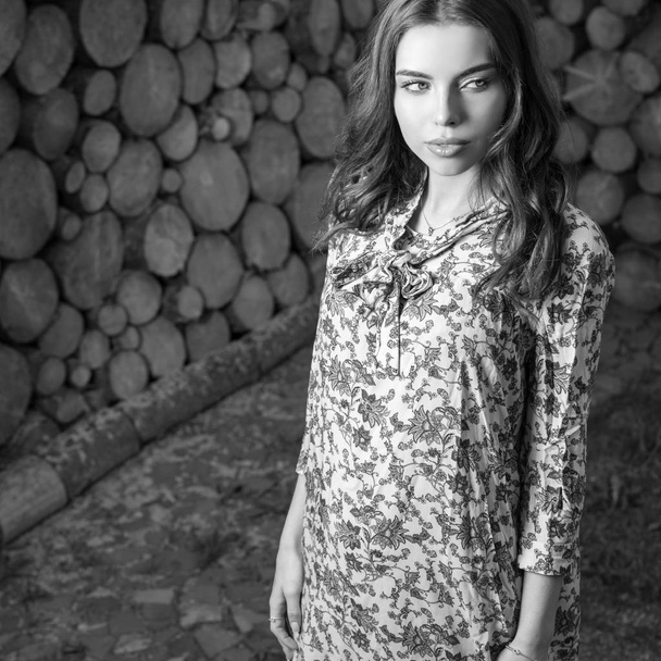 Beautiful women portrait against wooden wall. Black-white photo. - Fotografie, Obrázek
