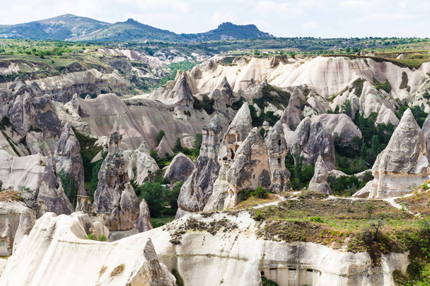 Travel to Turkey - old carved from rocks houses in Goreme National Park in Cappadocia in spring - Φωτογραφία, εικόνα