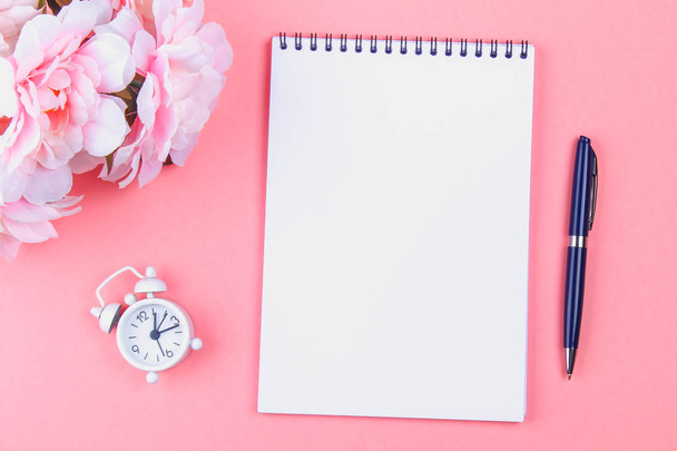 Empty notebook with blue pen on a pink pastel background. mock-up, frame, template - 写真・画像