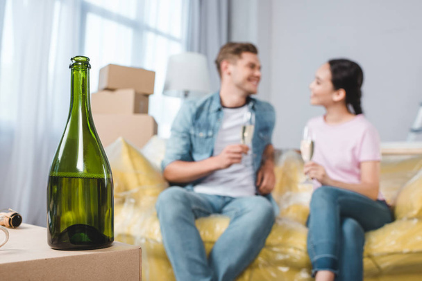beautiful young couple celebrating moving into new home with champagne - 写真・画像