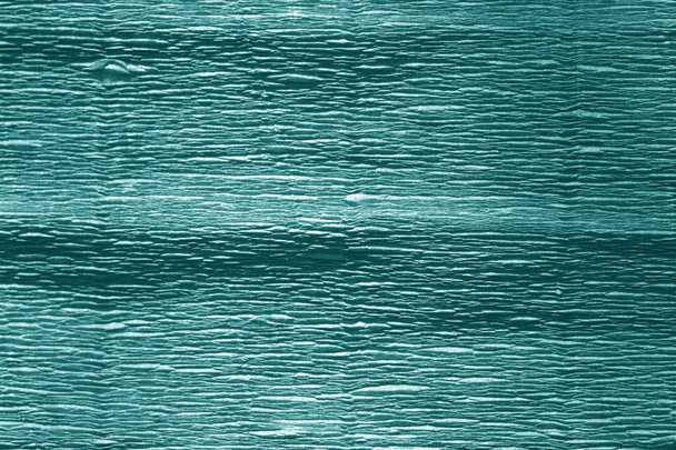Crêpe papier met blur effect in cyaan kleur. Abstracte achtergrond en textuur. - Foto, afbeelding