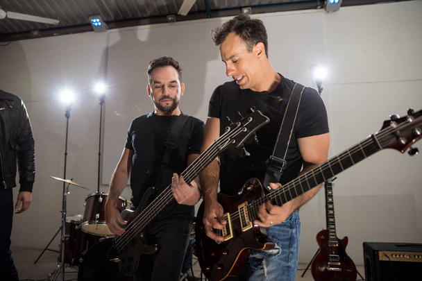 Dos guitarristas actuando en el escenario durante un concierto en vivo
 - Foto, Imagen