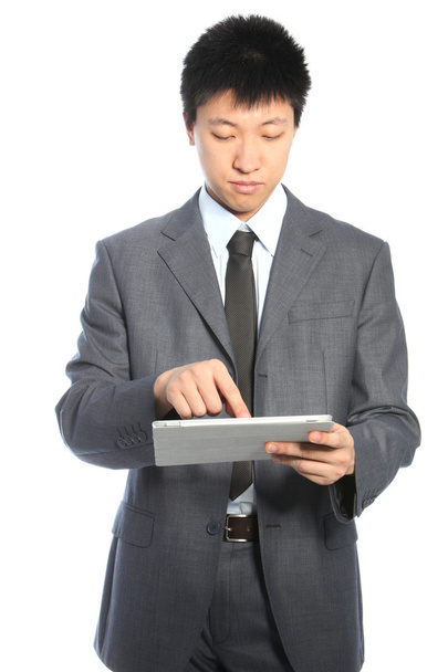 Young Asian businessman working on a PC tablet - Foto, immagini
