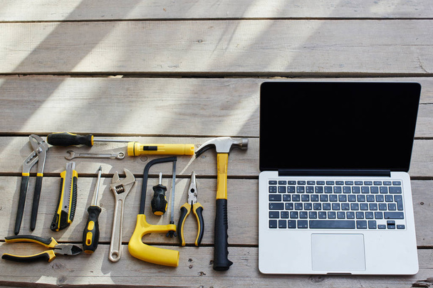 laptop and repair tools on wooden background with copy space - 写真・画像