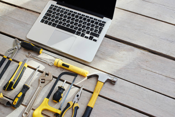 laptop and repair tools on wooden background with copy space - Foto, Imagen