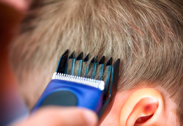 Child Haircut with Hairclipper. Close-up. - 写真・画像