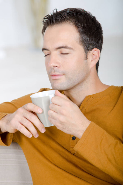 man enjoying a cup of coffee - Фото, зображення