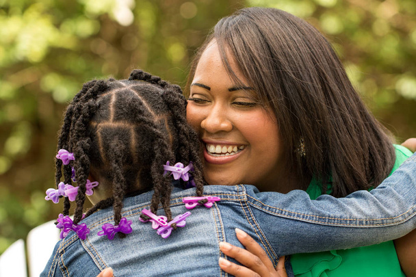 Happy African American mother and daughter. - 写真・画像