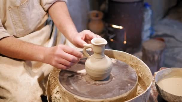 Potter at work. Potter making ceramic pot on the pottery wheel - Footage, Video
