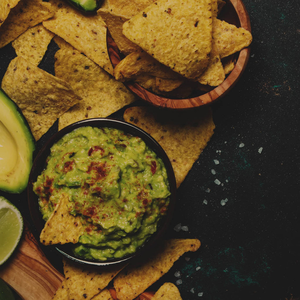 Spicy Mexican Food, Corn Nachos and Guacamole Sauce, Food Background, Top View - Foto, afbeelding