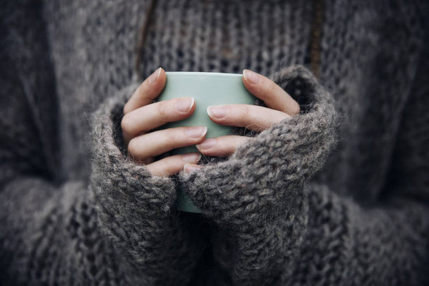 Close up view at young woman holding mug outdoor - Photo, Image