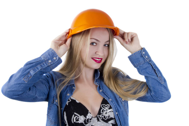 Young woman in a construction orange helmet - Foto, Bild
