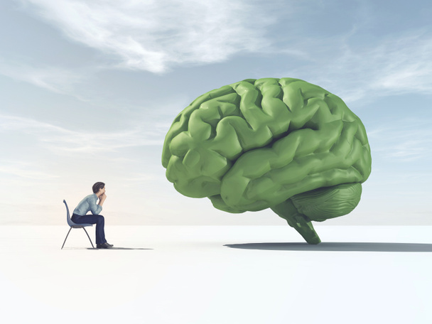 Mann schaut auf ein grünes Gehirn auf einem Feld. Dies ist eine 3D-Darstellung - Foto, Bild