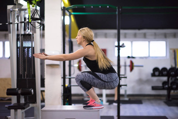 young athletic woman training  jumping on fit box at cross fitness gym - Foto, imagen