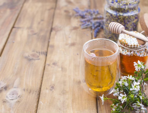 Tea with herbs, lavender and honey on a wooden background. Natural health. Free space for text. Copy space - Fotografie, Obrázek