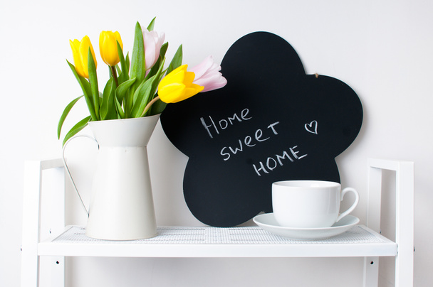 home interior decoration: a bouquet of tulips, a cup and a chal - Photo, Image