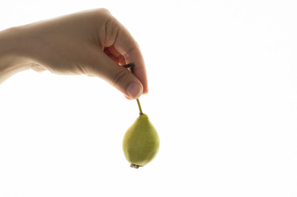 Female hand and fresh pear - Φωτογραφία, εικόνα