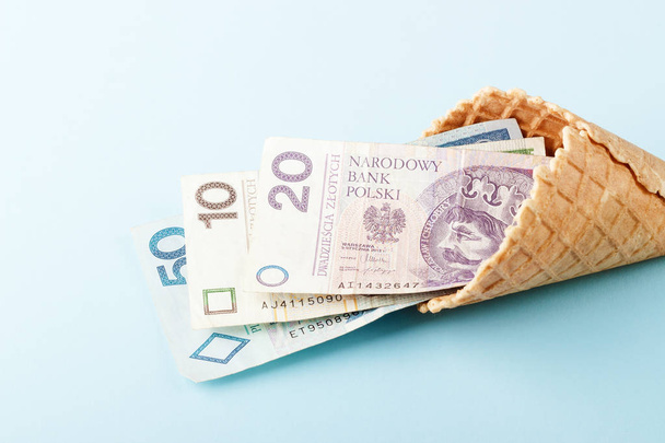 Monetary signs: Polish zloty on a blue paper background and beautiful packaging - Photo, Image