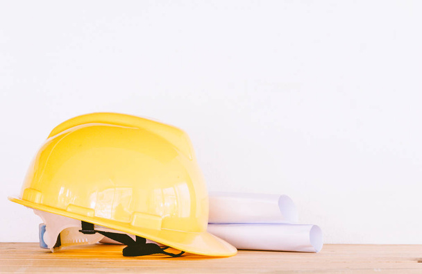 Engineer safety helmet on wooden table - Valokuva, kuva