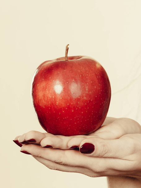 Diet and slimming, healthy food, fruits concept. Woman hand holding big red apple - Foto, afbeelding