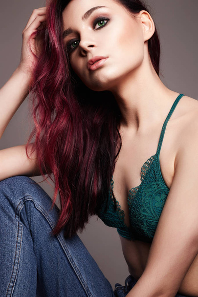 Fashion portrait. Young woman with color hair. Beautiful sexy model Girl in jeans and underwear. Trendy Dyed Hair color and Make-up - Photo, image