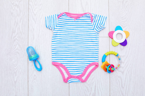 Flat lay composition with baby clothes and accessories on wooden background - Foto, Bild