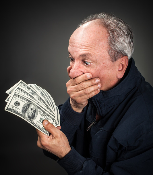 anciano con abanico de dólares
 - Foto, imagen