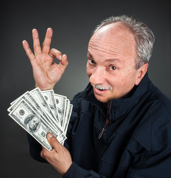 літній чоловік показує шанувальника грошей
 - Фото, зображення
