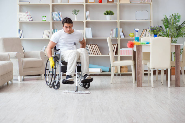 Disabled man cleaning floor at home - Fotoğraf, Görsel