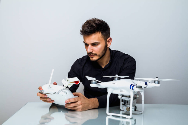 Young Man setting up a drone for first fly indoor - Fotografie, Obrázek