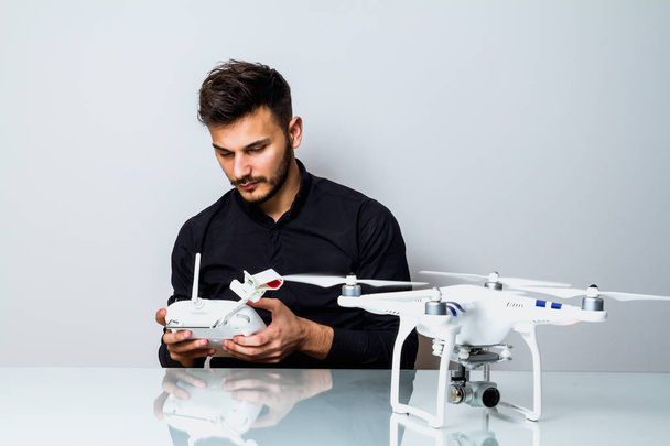 Young man playing with his drone - Photo, image