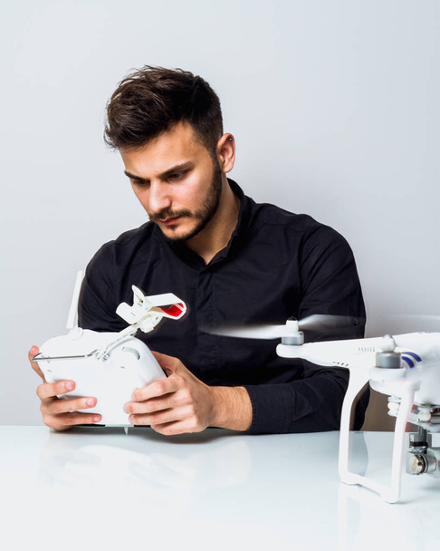 Young man playing with his drone - Foto, imagen