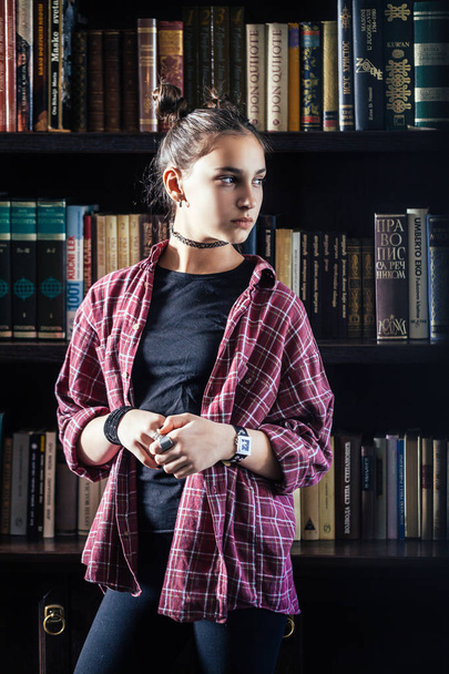photo of young stylish brunette woman with hairstyle posing at library - Fotografie, Obrázek