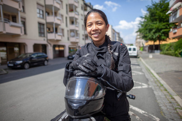 Nő egy motorkerékpár egy fekete bukósisak - Fotó, kép