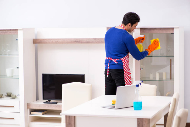 Contractor man cleaning house doing chores - Foto, Bild