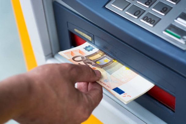 Taking money out of the ATM - Photo, Image