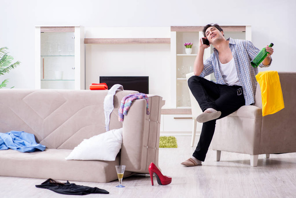 Man with mess at home after house party - Photo, Image