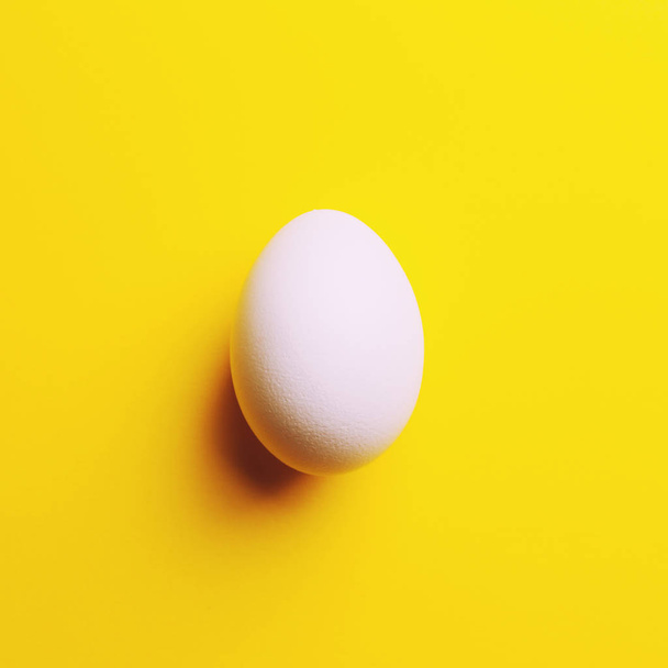 white raw egg on yellow background, close up - Foto, Imagem