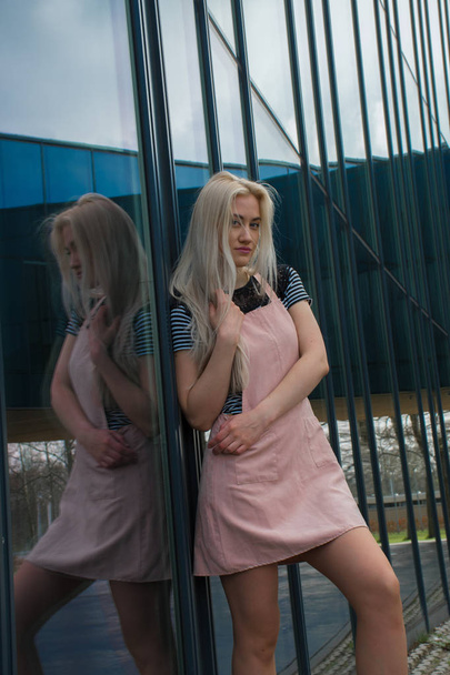 fille blonde près d'un immeuble miroir
 - Photo, image