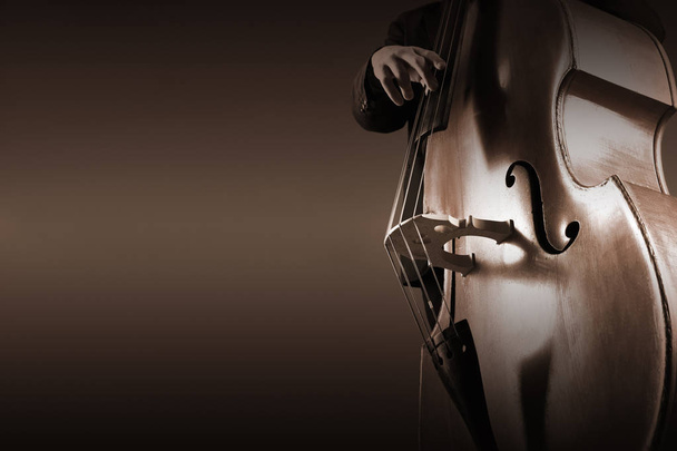 Double bass player contrabass playing. Jazz bassist with music instrument closeup - Foto, afbeelding