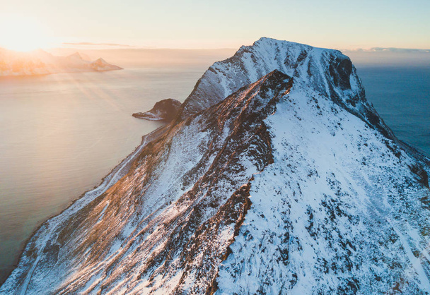 Norwegian winter sunny mountain landscape blue sky view with mountains, fjord, Norway, Ryten peak - famous mountain in Lofoten Islands, Moskenes municipality, Nordland, shot from drone - Photo, image