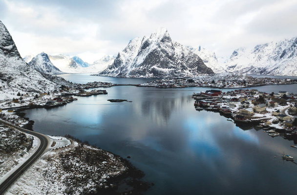 Beautiful winter snowy wide-angle summer aerial view of Reine, Norway, Lofoten Islands, with skyline, mountains, famous fishing village with red fishing cabins, Moskenesoya, Nordland, shot from dron - Fotoğraf, Görsel