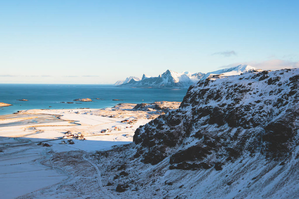 View of mountain landscape in Northern Norway, Lofoten Islands, Nordland, on the way to Ryten mountain and Kvalvika beach, with a groups of hikers, and mountains around, sunny winter day - Foto, Imagem