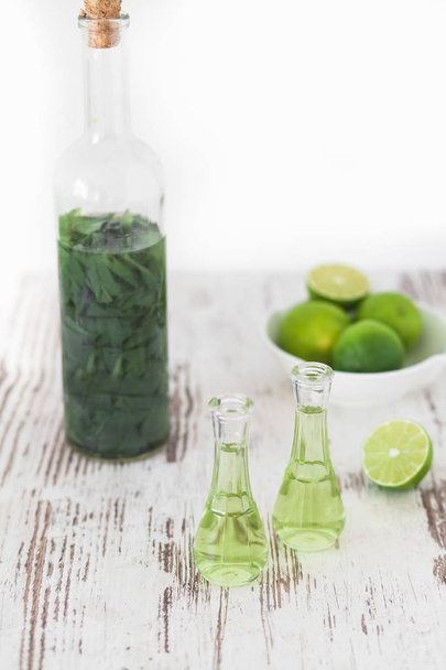 Herbal brandy with healty leafs and lime - Foto, Imagem