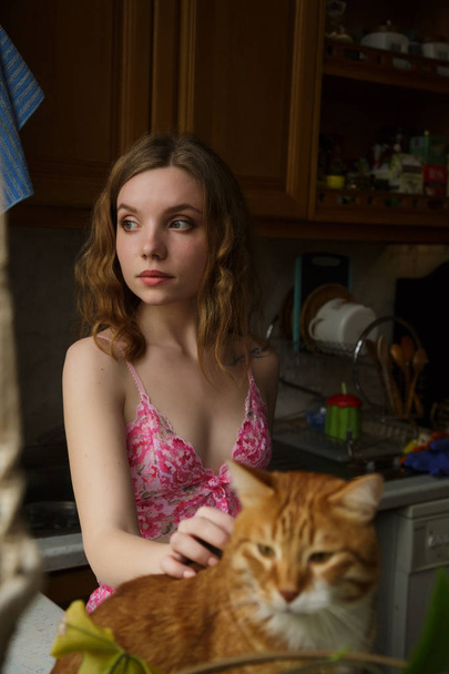 Menina bonita com ruivas cabelo com um gato
 - Foto, Imagem
